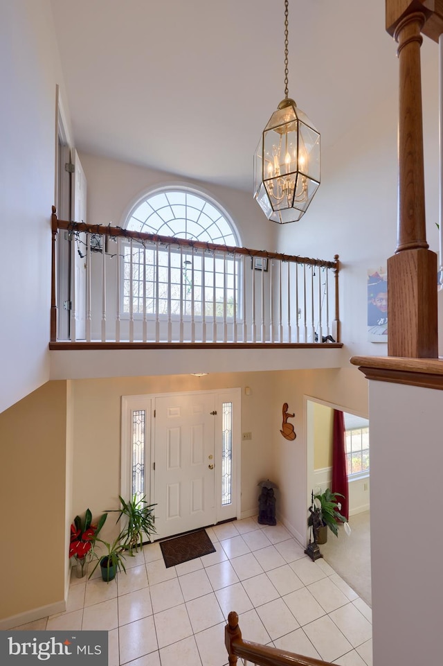 entryway with decorative columns, a chandelier, and a wealth of natural light