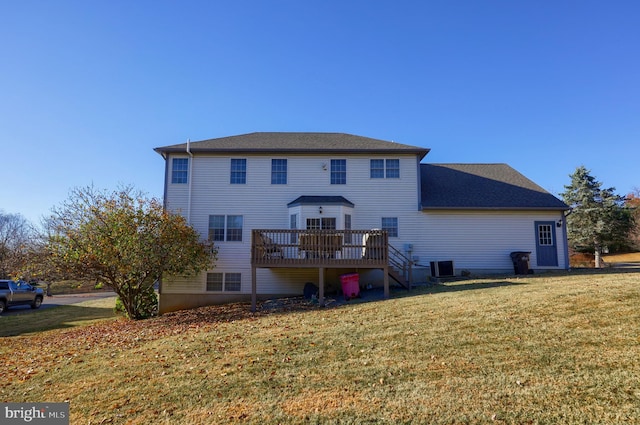 rear view of house featuring a wooden deck, a lawn, and central AC unit