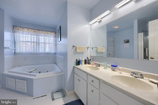 bathroom with a bathtub, tile patterned flooring, and vanity