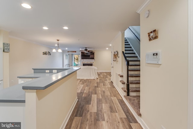 interior space featuring an inviting chandelier, light hardwood / wood-style flooring, and ornamental molding