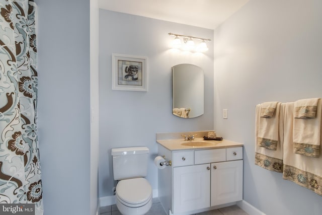 bathroom with vanity, toilet, and tile patterned floors