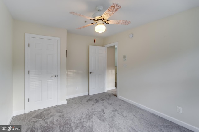 unfurnished bedroom featuring light carpet and ceiling fan