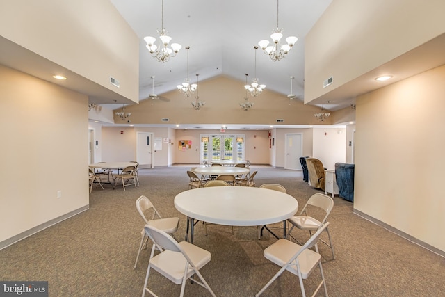 dining space featuring high vaulted ceiling and carpet flooring