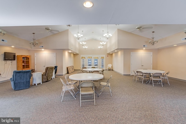 carpeted dining room featuring high vaulted ceiling and ceiling fan