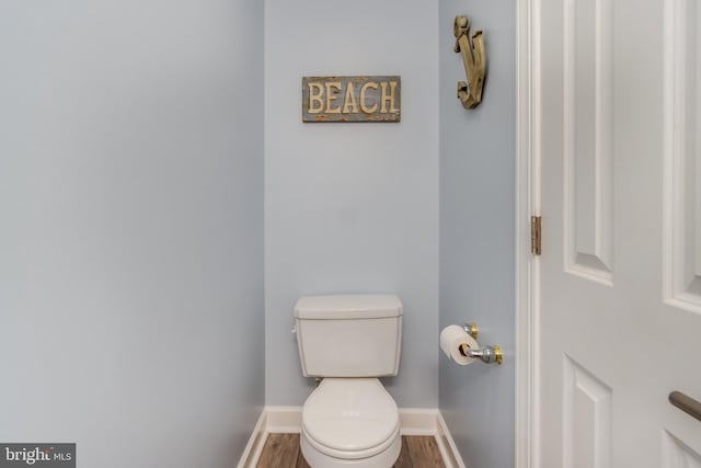 bathroom with toilet and hardwood / wood-style flooring