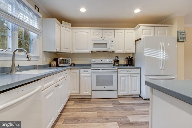 kitchen with ornamental molding, light hardwood / wood-style flooring, white cabinetry, and white appliances