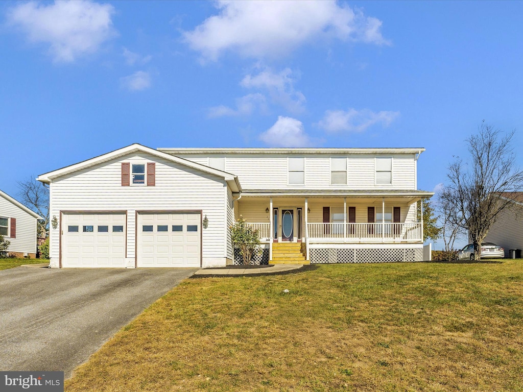 view of front of home featuring a porch, a front lawn, and a garage