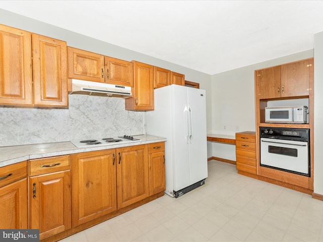 kitchen featuring decorative backsplash and white appliances