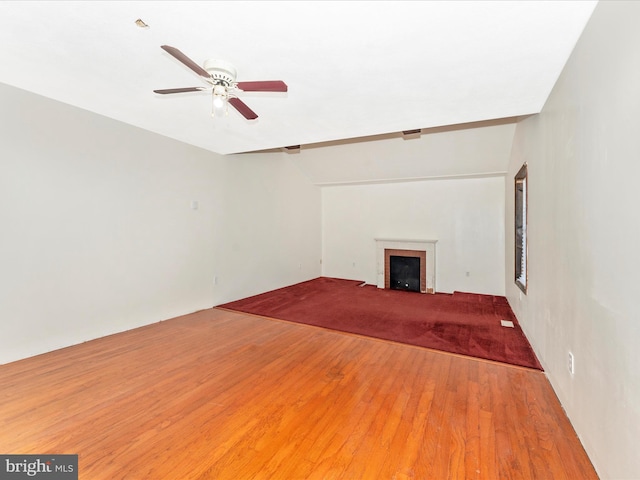 unfurnished living room with lofted ceiling, wood-type flooring, and ceiling fan