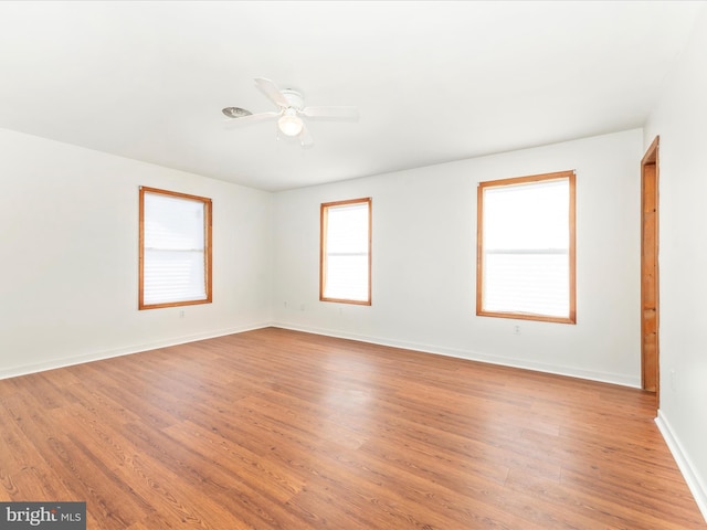 unfurnished room with ceiling fan and light wood-type flooring