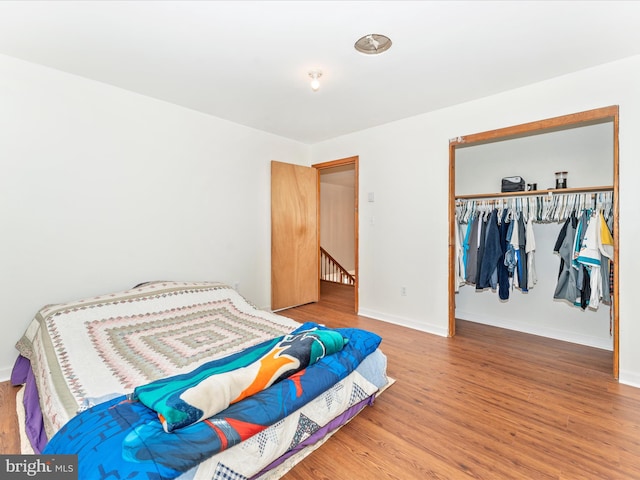 bedroom featuring hardwood / wood-style floors and a closet