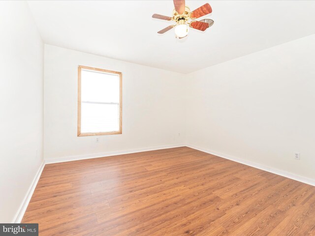 spare room with light wood-type flooring and ceiling fan