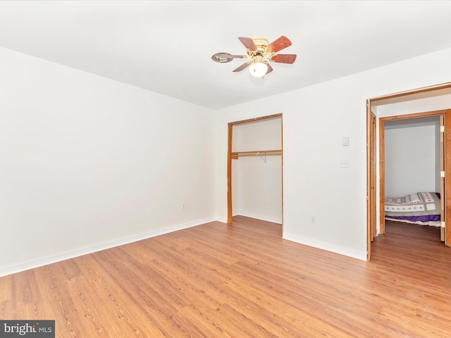 unfurnished bedroom featuring a closet, ceiling fan, and light wood-type flooring