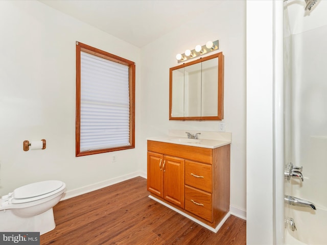 bathroom featuring vanity, hardwood / wood-style flooring, and toilet