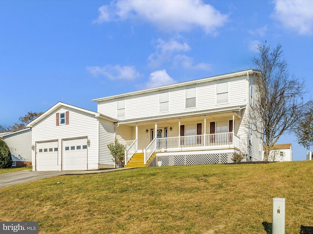 view of property featuring a garage, a front lawn, and a porch