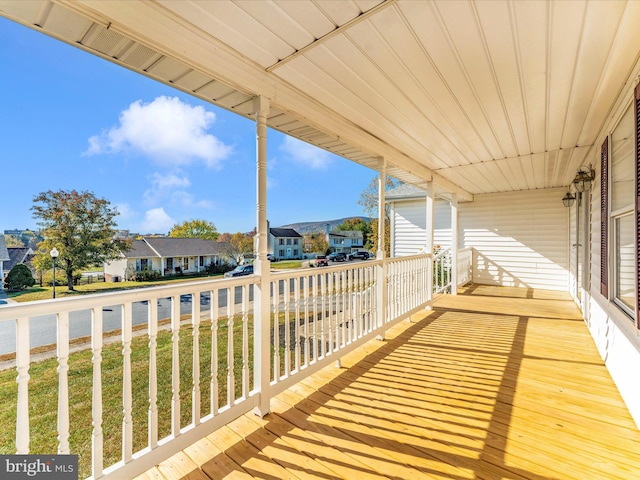 wooden terrace featuring a lawn