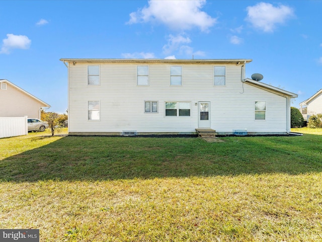 back of property with a lawn