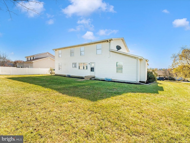 rear view of house with a yard