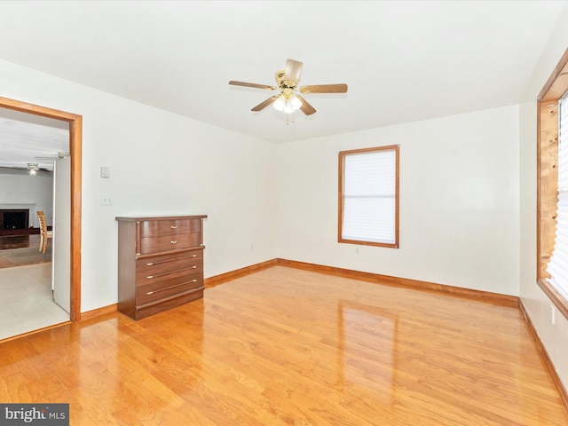 unfurnished room featuring light hardwood / wood-style flooring and ceiling fan