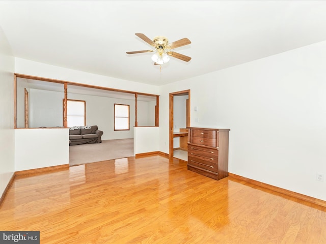 empty room featuring ceiling fan and light hardwood / wood-style flooring