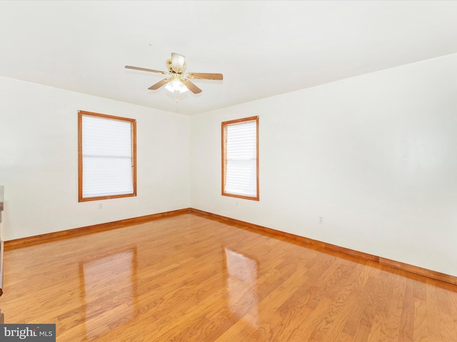 spare room with light wood-type flooring and ceiling fan