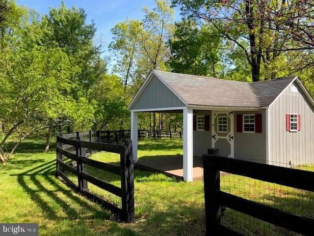 view of outbuilding with a lawn