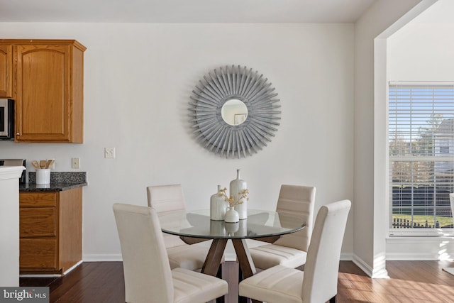 dining area with dark hardwood / wood-style flooring