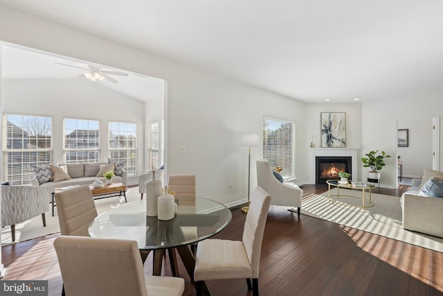 dining area with hardwood / wood-style floors, ceiling fan, and lofted ceiling