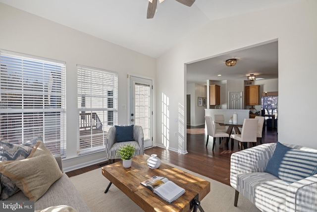 living room featuring dark wood-type flooring, lofted ceiling, and ceiling fan