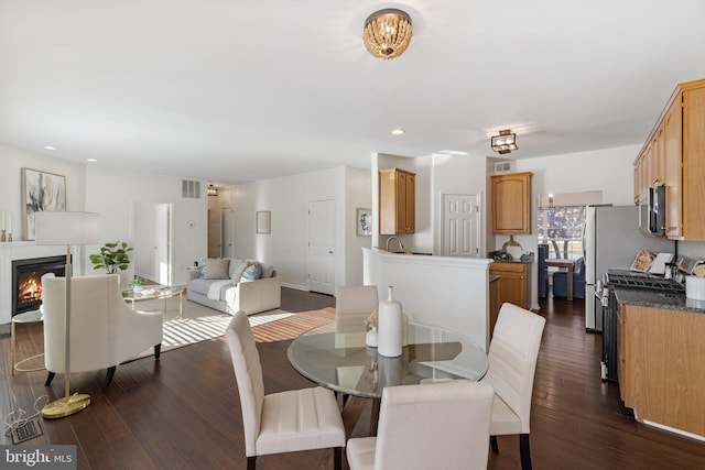 dining space with sink and dark hardwood / wood-style floors