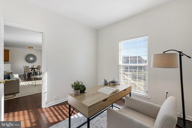 office space with dark wood-type flooring