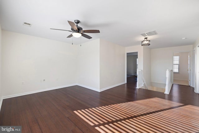 spare room featuring dark wood-type flooring and ceiling fan