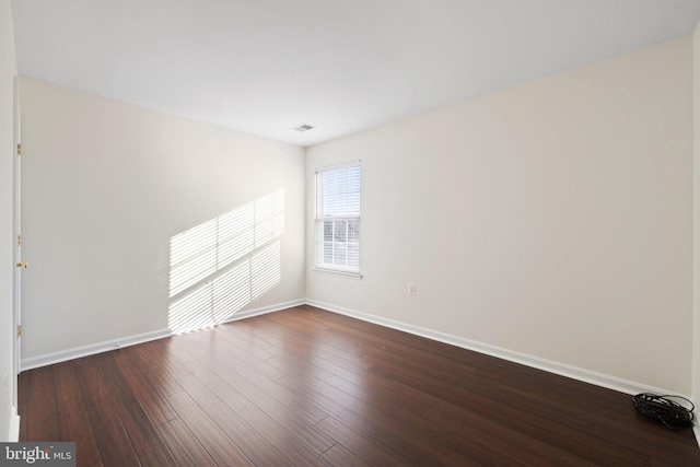 empty room with dark hardwood / wood-style floors