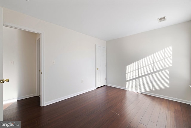 unfurnished room featuring dark hardwood / wood-style floors