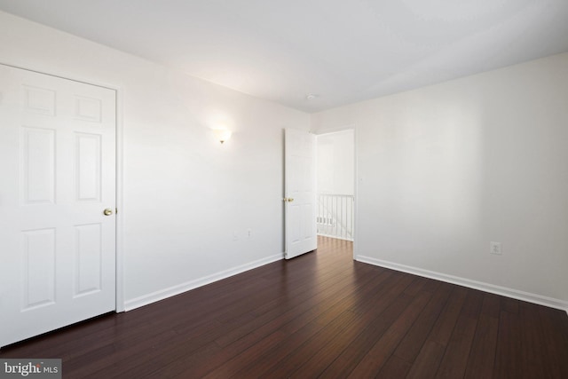 spare room with dark hardwood / wood-style floors