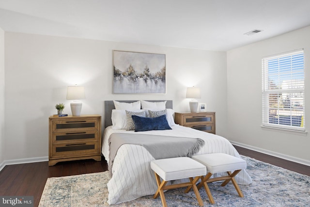 bedroom with dark wood-type flooring