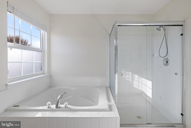 bathroom with separate shower and tub