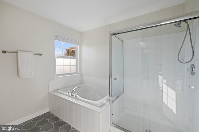 bathroom featuring tile patterned flooring and plus walk in shower