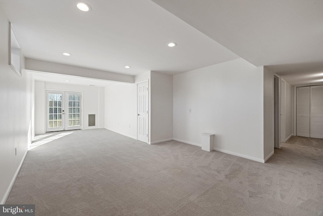 unfurnished room with light colored carpet and french doors