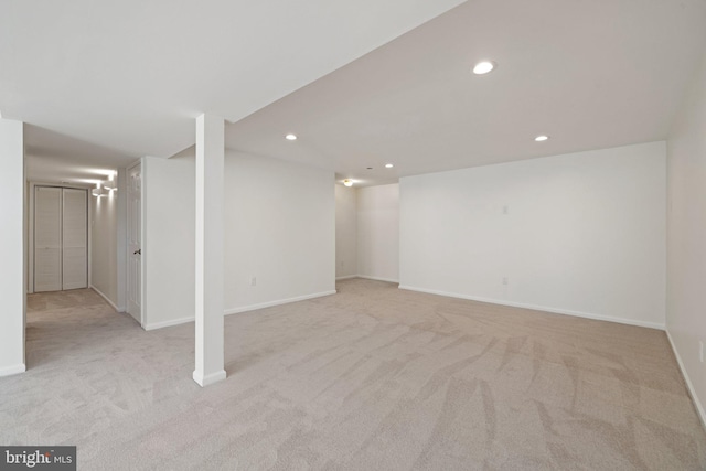 basement featuring light colored carpet