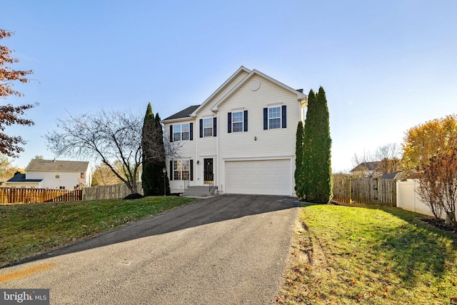 front facade featuring a garage and a front lawn