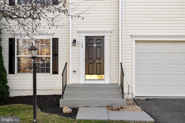 doorway to property with a garage