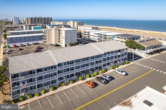 bird's eye view with a water view and a beach view