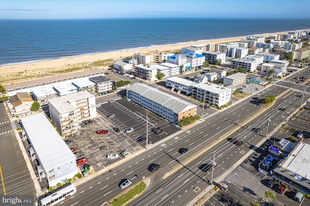 birds eye view of property featuring a view of the beach and a water view