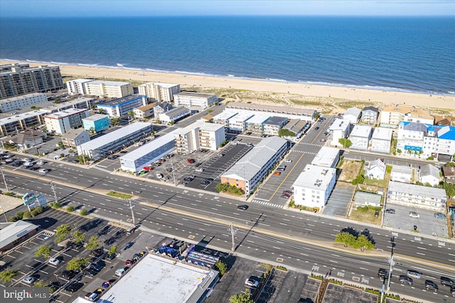 aerial view with a water view and a beach view