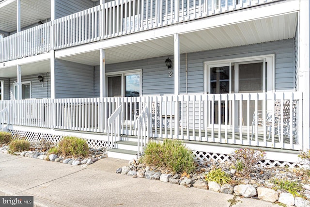 view of exterior entry with a porch