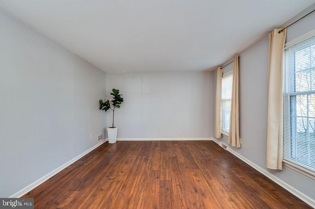 spare room with dark hardwood / wood-style flooring