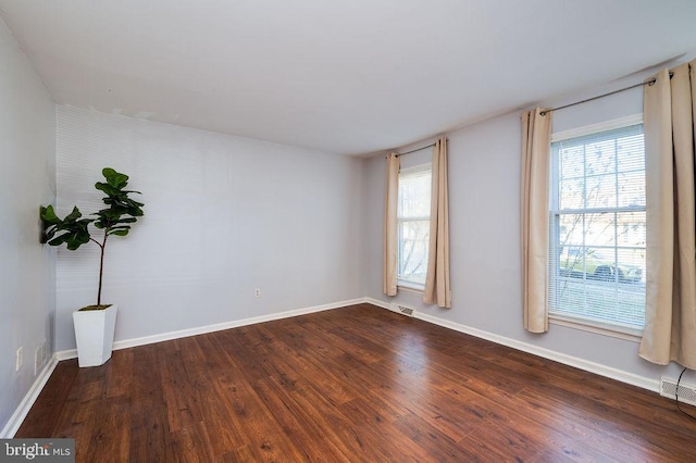 unfurnished room featuring dark wood-type flooring