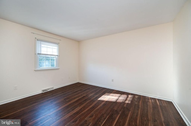 unfurnished room with dark hardwood / wood-style floors