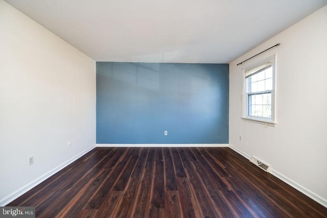 empty room featuring dark hardwood / wood-style flooring